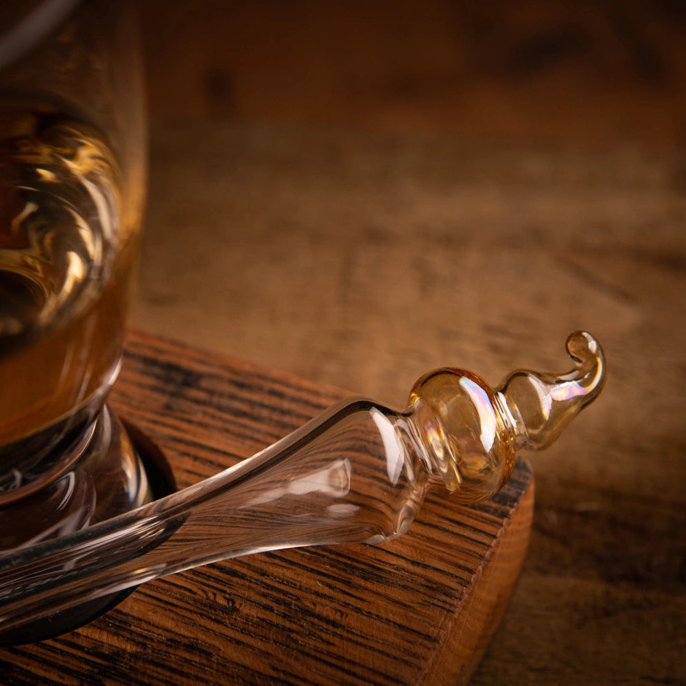 Glass Whisky water Dropper on a wooden surface